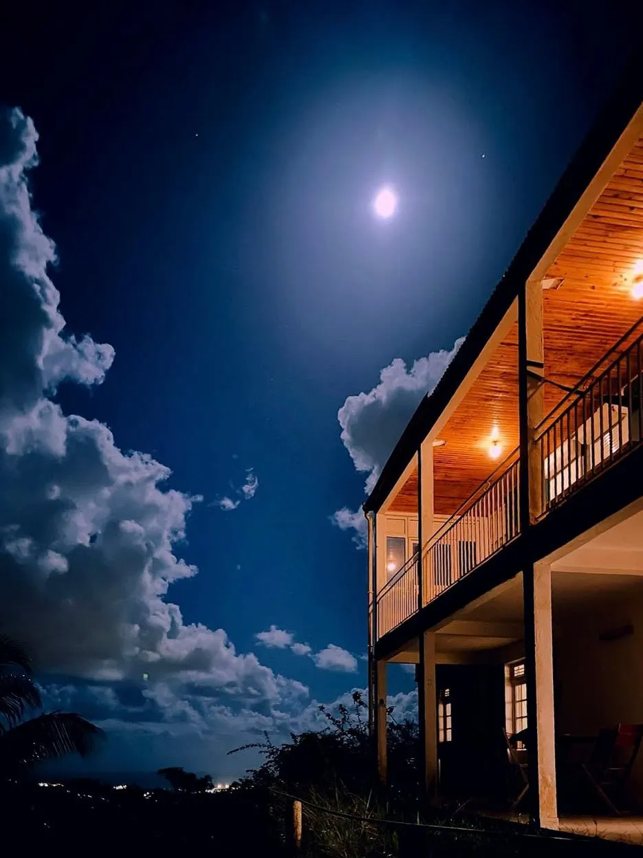 The residency house at night, under the moon
